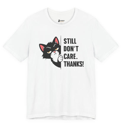 Funny cat t-shirt with Still Don’t Care Thanks slogan and black peeking cat graphic on white shirt