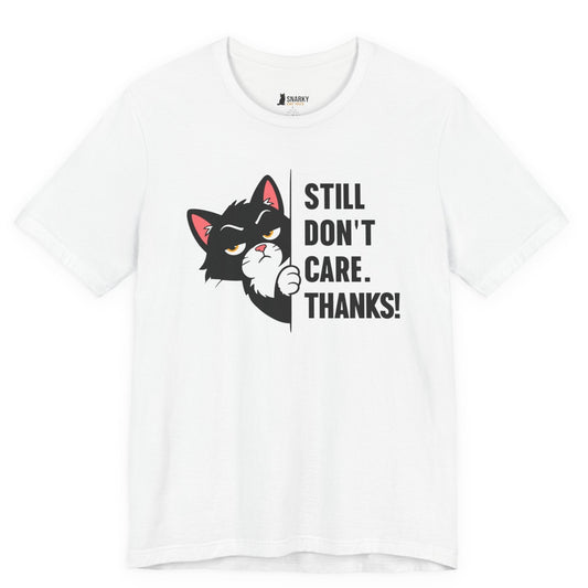 Funny cat t-shirt with Still Don’t Care Thanks slogan and black peeking cat graphic on white shirt