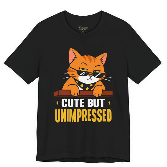 Funny cat t-shirt with Cute But Unimpressed slogan and sunglasses cat graphic on black shirt