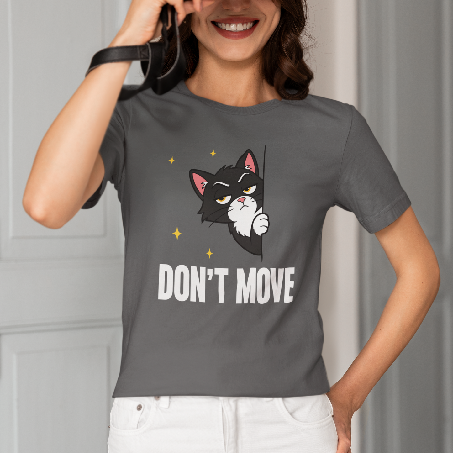 Model wearing Don’t Move Peeking Cat T-Shirt with peeking black cat graphic design