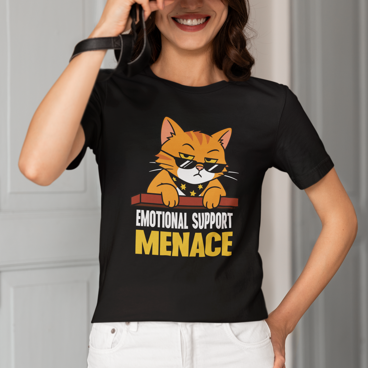 Model wearing Emotional Support Menace Sunglasses Cat T-Shirt with orange cat graphic design