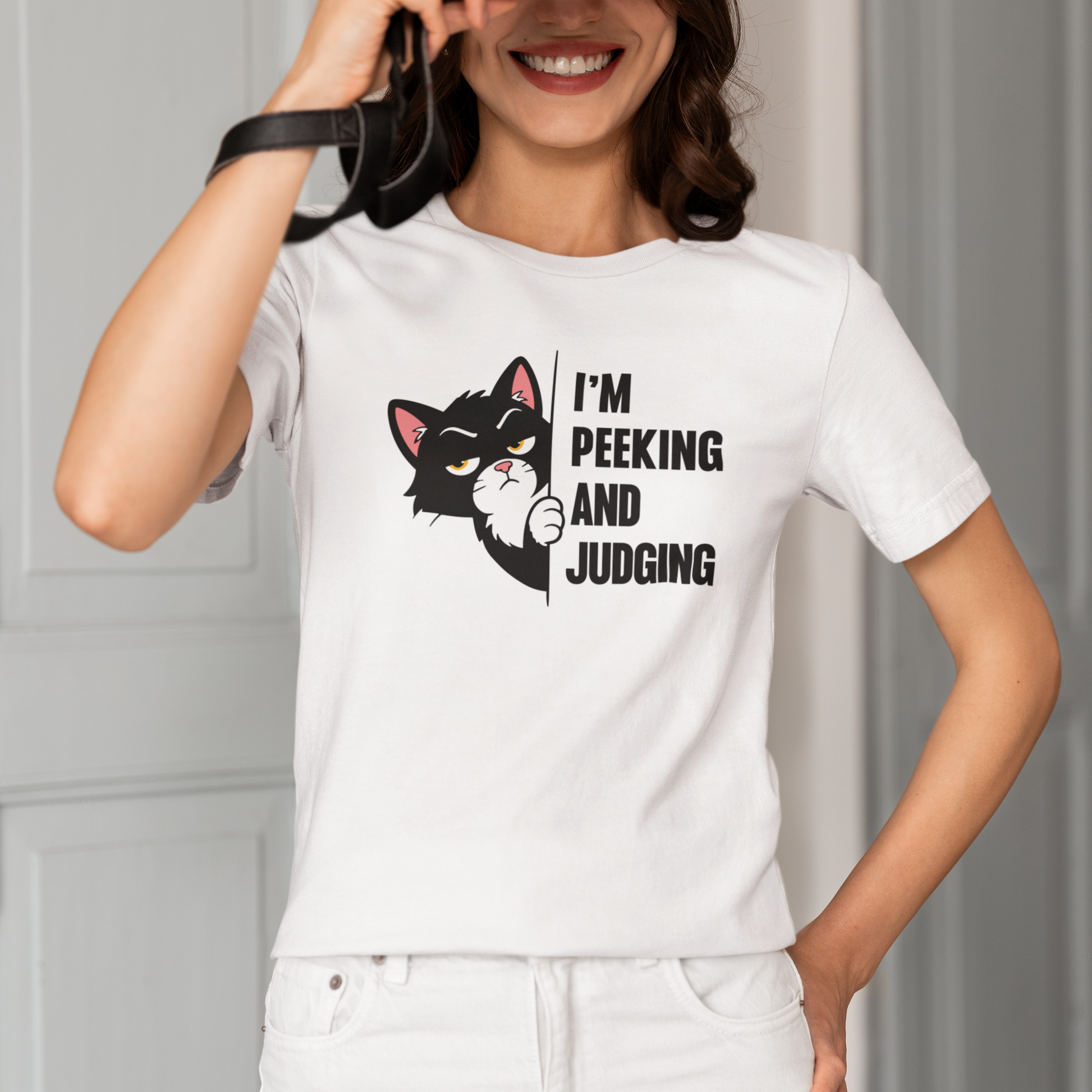 Model wearing Peeking and Judging Peeking Cat T-Shirt with black peeking cat graphic design