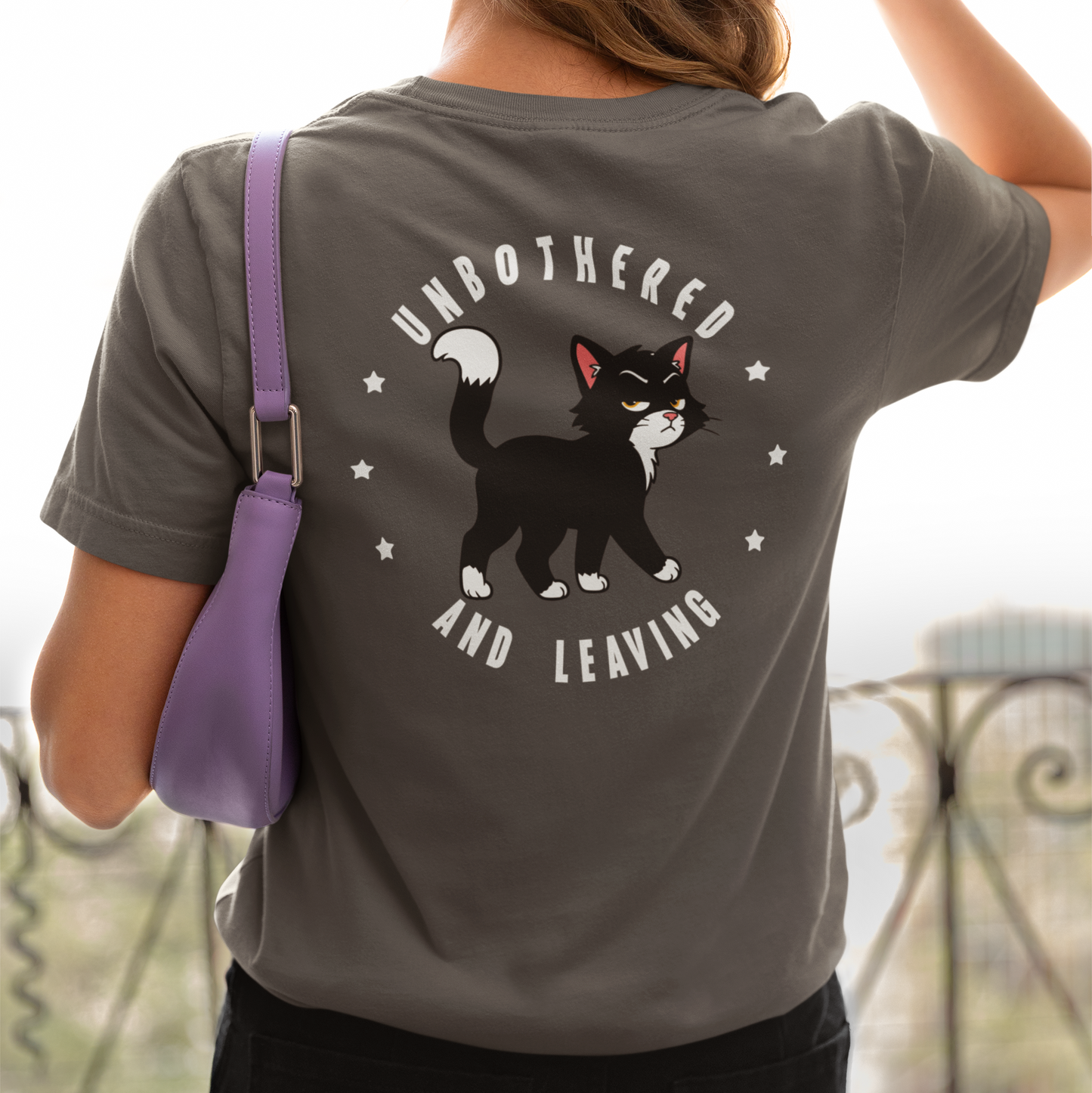 Model wearing Unbothered and Leaving walking Cat T-Shirt with black cat back print design
